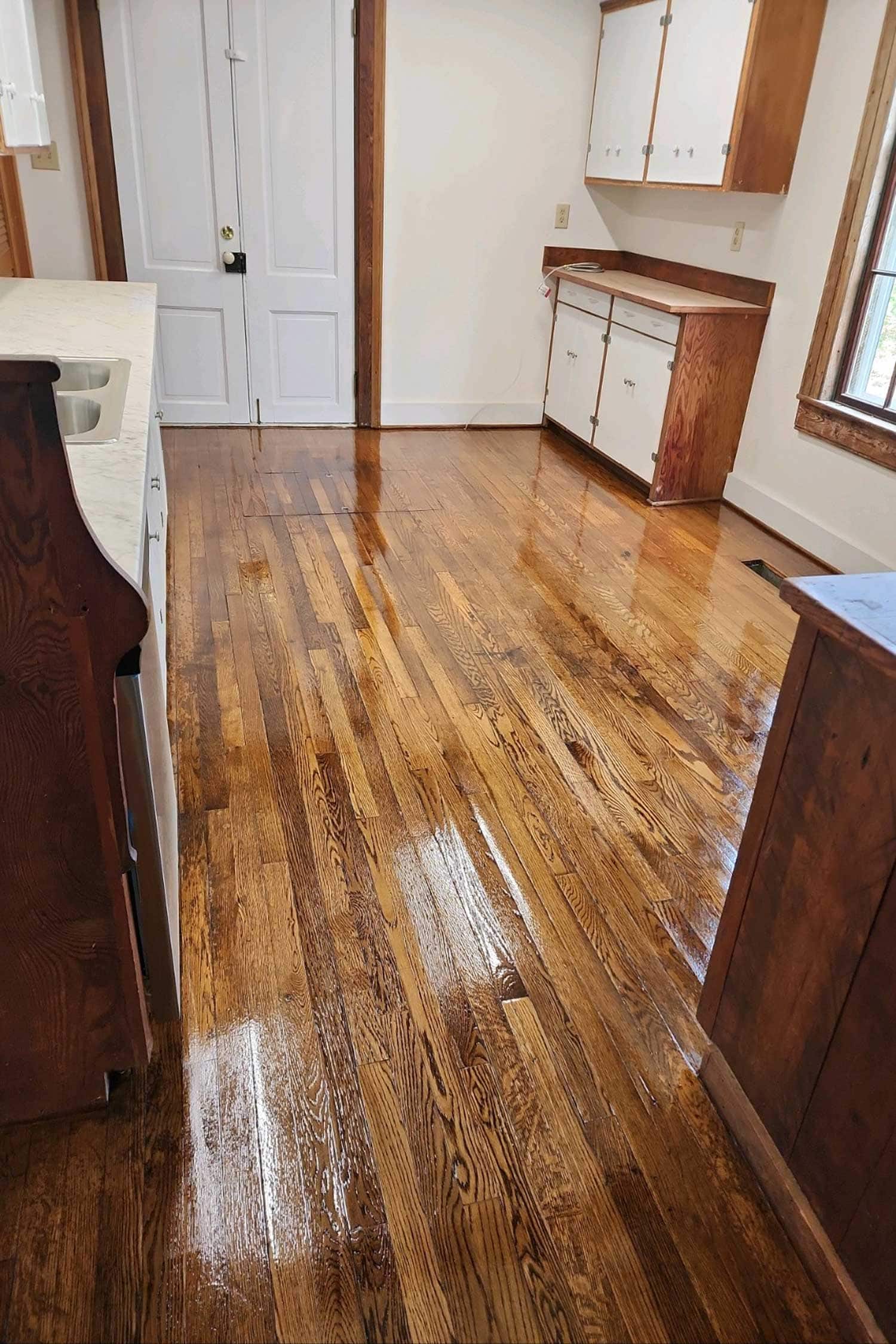 Character-grade oak floor with a glass-smooth polyurethane finish — Richmond hardwood refinishing