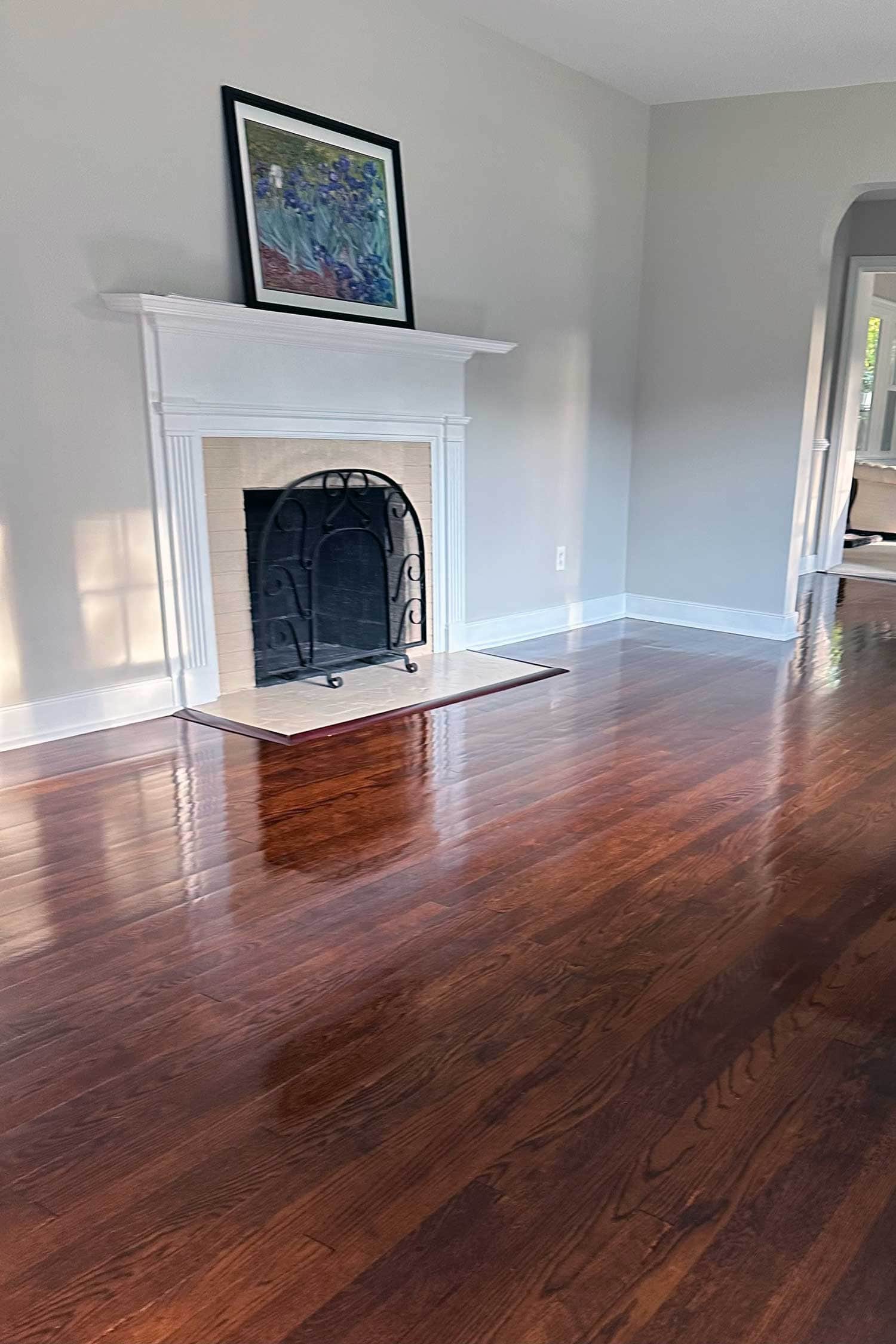 Wide-plank heart pine floor mid-recoat with staircase and windows — Virginia historic-home refinishing